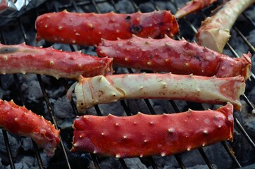 king crab legs and claws on coal barbeque