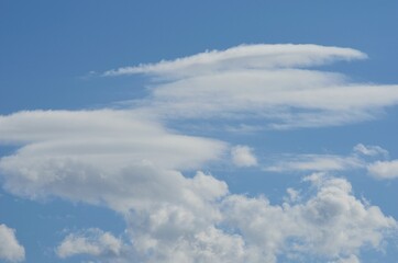 white cloud shapes on blue summer sky