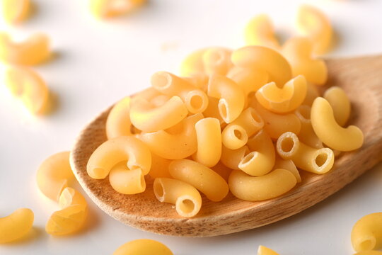 Uncooked Elbow Macaroni On A White Background.
