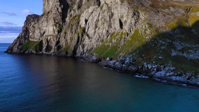 Aerial view of the famous Ryten mountain sinking down to the clear turquoise waters of the Mediterranean sea.
