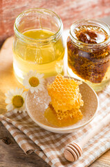 Close up honeycomb with honey in glass jar