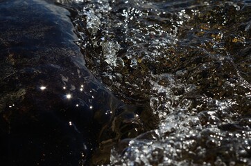 beautiful clean water river flow with air bubbles closeup 