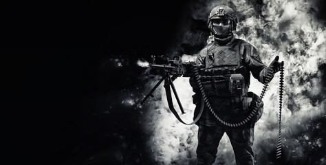 Portrait of a fighter of a special unit. He lies on the ground and shoots from a heavy machine gun....