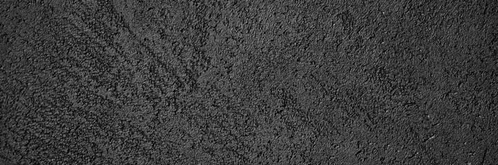 abstract textured dark gray or black surface texture rough background, cement concrete floor or wall. banner