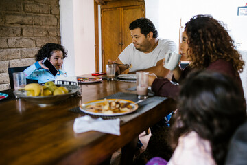 hispanic family having breakfast at home in Latin America