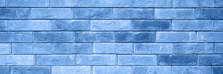 pattern of decorative gray slate stone wall surface as a background. tinted classic blue color trend 2020 year. banner