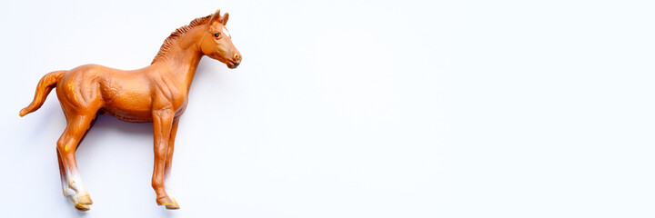 Naklejka na ściany i meble Figurine of a horse toy on white background. banner
