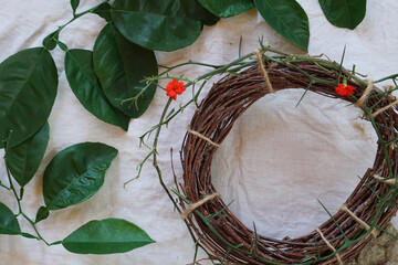 Easter consept with Crown of Thorns and green twig of tree, stone  on  white cloth background