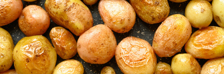 Golden roasted potatoes in the skin. background. banner
