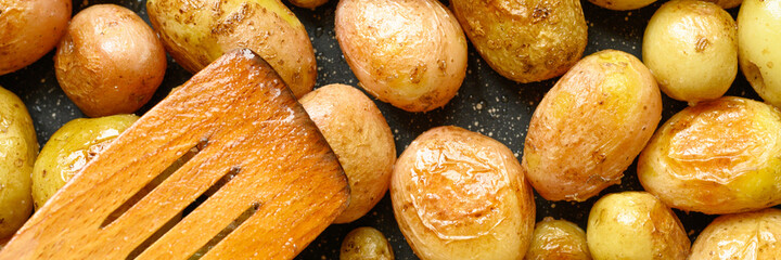 Golden roasted potatoes in the skin. banner