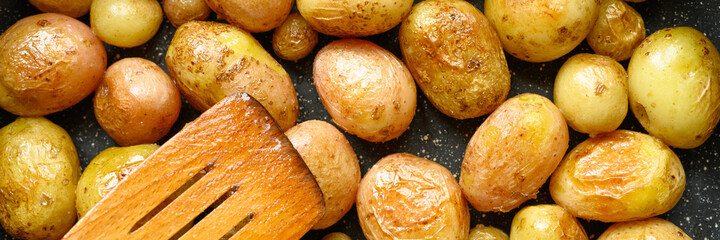 Golden roasted potatoes in the skin. banner