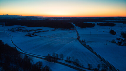 Sunset of a winter landscape with roads