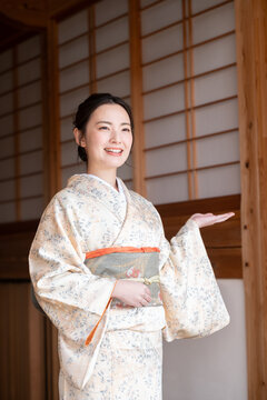 Vertical image of a beautiful young landlady, easy to use as a banner material for travel and inns. omotenashi,