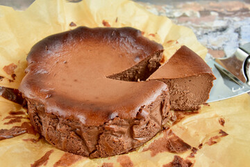 Homemade delicious chocolate burnt cheesecake on parchment paper. 