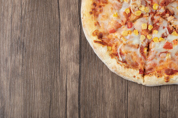 Pizza in tomato sauce with marinated corn seeds and melted cheese on the top