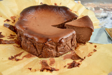 Homemade delicious chocolate burnt cheesecake on parchment paper. 