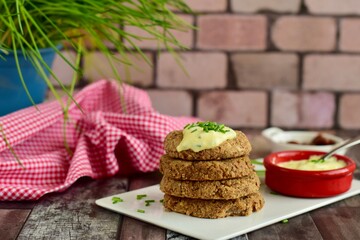 Vegan pinto bean patties with vegan mayo mustard sauce garnish with chives
