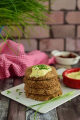 Vegan pinto bean patties with vegan mayo mustard sauce garnish with chives