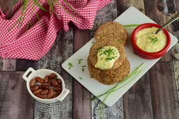 Vegan pinto bean patties with vegan mayo mustard sauce garnish with chives