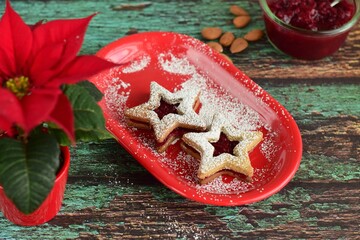 Christmas Linzer cookies with raspberry jam and powdered sugar