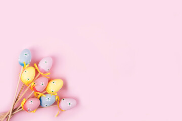 Obraz na płótnie Canvas Colorful Easter eggs over pink background.