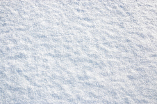White snow winter texture. Seasonal fresh white color snow nature backdrop wallpaper.  Crisp shiny  frosty snow on sunny day outdoor.