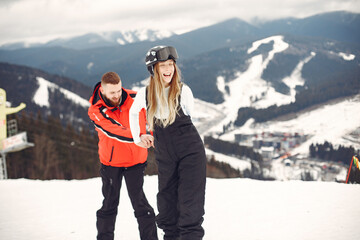 Couple in sport clothes. People spending winter vacation on mountains