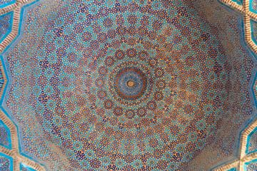 Beautiful blue white brown traditional floral and geometric design inside cupola at ancient Shah...
