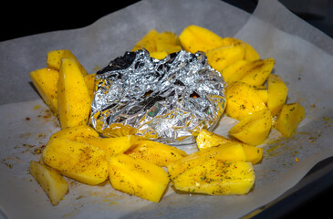 Potato with meat frying in the oven. Home food preparing.