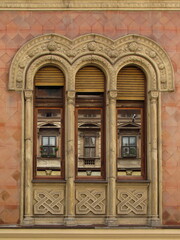 Three windows with reflection from the other side of the street