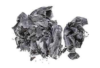 Burnt paper isolated on a white background, top view. The ashes of the paper. Charred paper scraps.