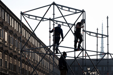 Construction workers assembling a scaffold