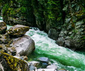 Naklejka na ściany i meble Fast Flowing River Waterfall Rapids Big Rocks Valley