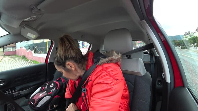 Fethiye, Turkey - 18th of February 2021: 4K Woman fastens the seat belt and tries to leave her parking place
