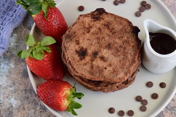 Double chocolate pancakes with fresh strawberries