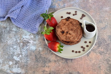 Double chocolate pancakes with fresh strawberries