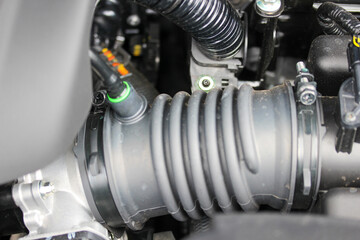 Various car engine parts including air intake hose
