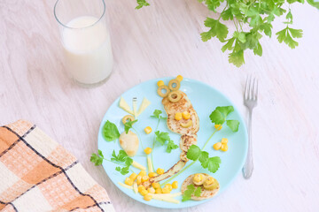 Plate with creative and simple breakfast  for children on table. food art for kids eating a little