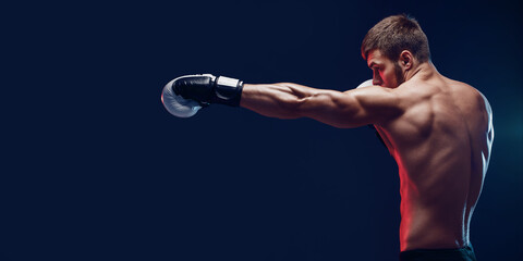 shirtless boxer with gloves on dark background. Isolate - obrazy, fototapety, plakaty