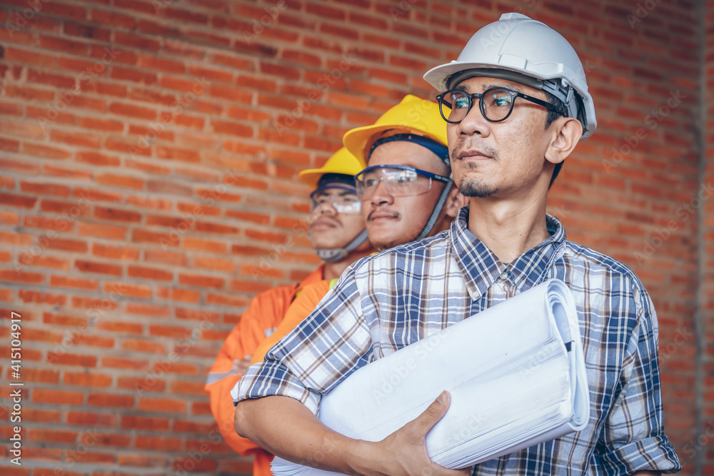 Aufkleber Structural engineer and architect wearing protective helmet with blueprint works on the building site.