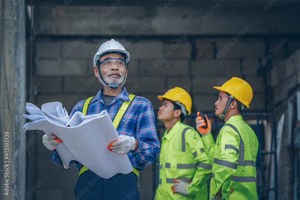 Aufkleber structural engineer and architect wearing protective helmet with blueprint works on the building sit