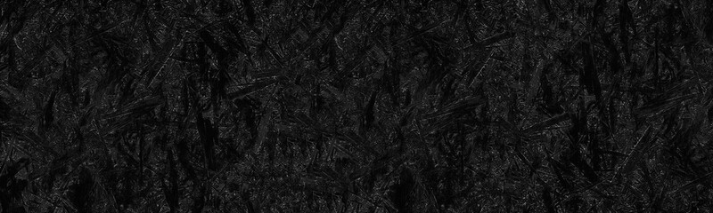 Black OSB texture. Textured dark gray wood panoramic surface. Gloomy grunge creative background
