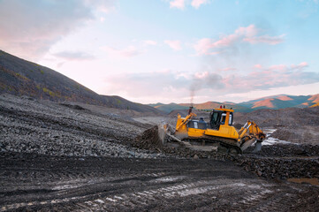 Bulldozer in  process of working in an industrial mountain area
