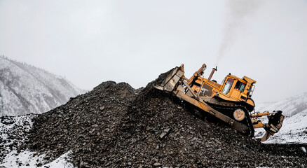 Bulldozer in  process of working in an industrial mountain area