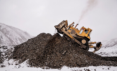 Bulldozer in  process of working in an industrial mountain area