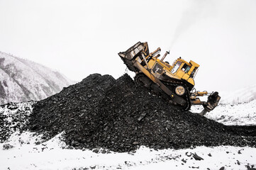Bulldozer in  process of working in an industrial mountain area