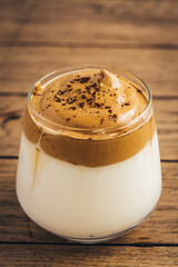 Iced fluffy creamy whipped trend drink with coffee foam and milk. Dalgona coffee.