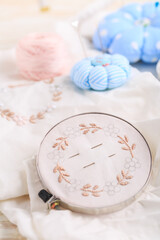 Canvas for embroidery in a round hoop, multi-colored thread mouline thread and other accessories for needlework.