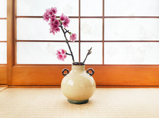 Image of cherry blossoms blooming in a Japanese vase