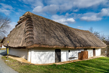 Fototapeta na wymiar Thatched roof, of a wine press house in Heiligenbrunn in Burgenland. This Wine Cellar Alley is one of the most beautiful Kellergasse in Burgenland and Austria. 13.02.2021